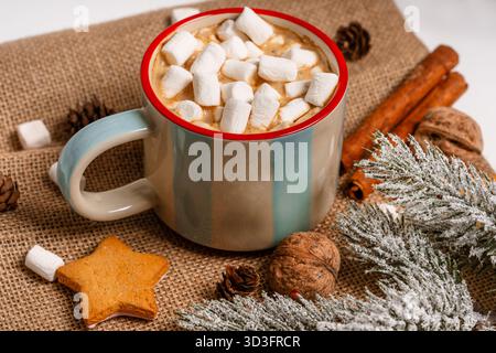 Mug with cocoa and marshmallows, cozy Christmas drink in a festive setting on an isolated background Stock Photo