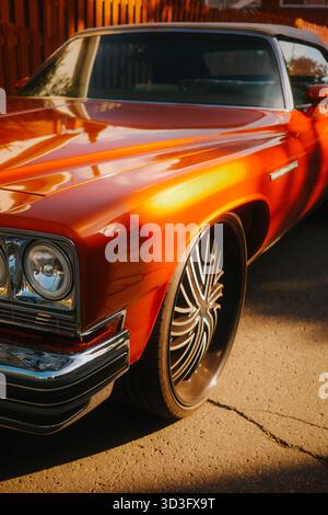 A stunning orange convertible classic car showcases its vintage charm. With a sleek design, this timeless vehicle exudes elegance and nostalgia, ready Stock Photo