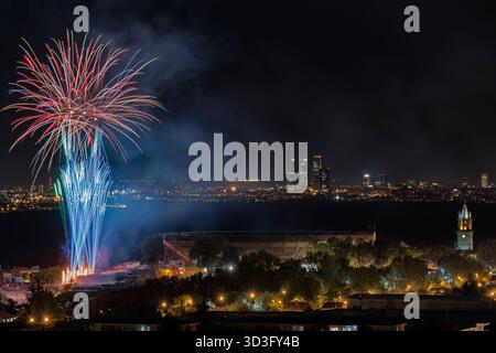 Dazzling fireworks illuminate the night sky over Colmenar Viejo, Madrid, creating a vibrant display of colors and lights against a backdrop of twinkli Stock Photo