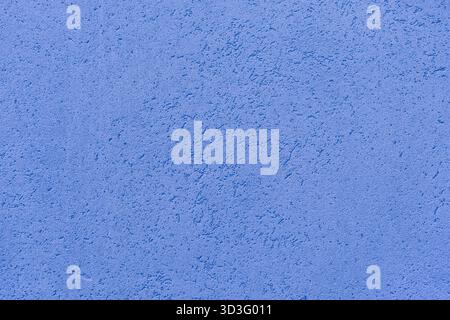Close-up of a blue textured wall showcasing a rough surface with subtle patterns. The image captures the tactile quality and intricate details of the Stock Photo