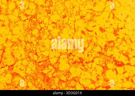Vibrant abstract marbled texture in bright orange and yellow tones, showcasing intricate patterns and organic shapes. Perfect for backgrounds or artis Stock Photo