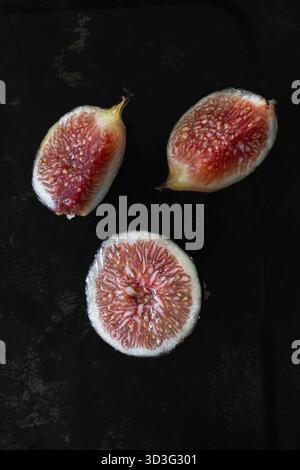 Fresh dark figs, black or purple figs arranged on a dark background Stock Photo