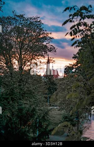 Wroclaw, Poland. The sky at sunset and a view of the Old Town through the trees. Stock Photo