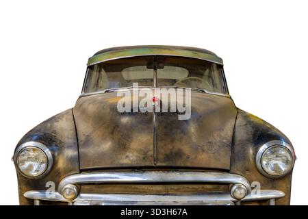 Heavily weathered and rusted American classic car isolated on a white background Stock Photo
