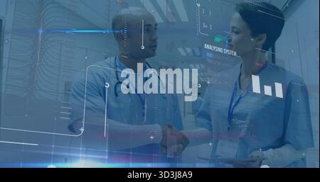 Two doctors sharing tablet data in hospital corridor with stethoscopes, badges, digital overlays Stock Photo