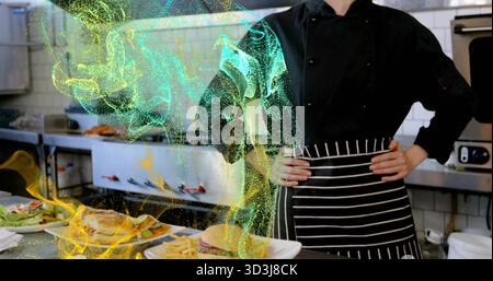 Chef wearing coat in restaurant kitchen with burgers on counter and swirling particles, copy space Stock Photo
