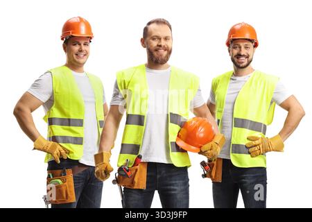 Team of construction workers in safety vests and helmets isolated on white background Stock Photo