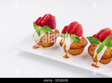 Food, Vanilla cupcakes with strawberry on white plate Stock Photo
