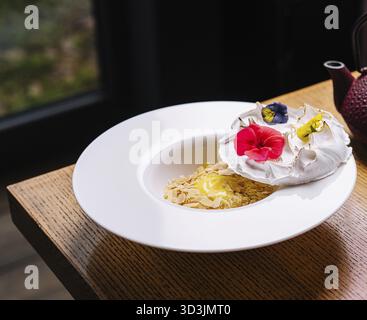 Food, Meringue on plate and almonds with vanilla custard Stock Photo