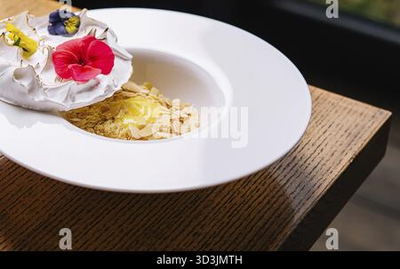 Food, Meringue on plate and almonds with vanilla custard Stock Photo