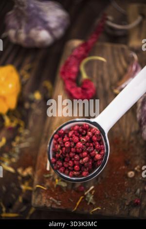 Red pepper whole seeds on spoon Stock Photo