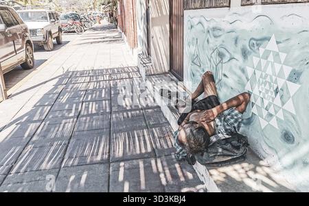 Homeless man sleeping on the floor in Zicatela Puerto Escondido Oaxaca Mexico Stock Photo