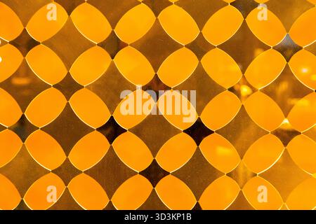 Yellow decorative translucent glass with a diamond pattern. Stock Photo