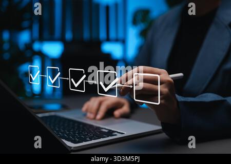 Project planning and workflow management concept. Person using laptop with virtual checklist and progress icons, represent task tracking, Stock Photo