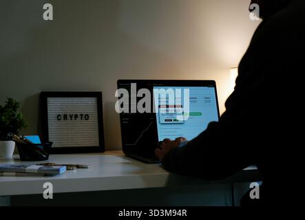 Middle Aged Gray Hat Hacker Minting Crypto Meme Coin for Potential Rug Pull Concept - Cryptocurrency Idea Based Around Creating New Coin Gets Virus Stock Photo
