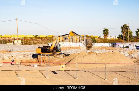 Industrial site with excavator and construction worker. Barcelona Spain 27.10.2025 Stock Photo