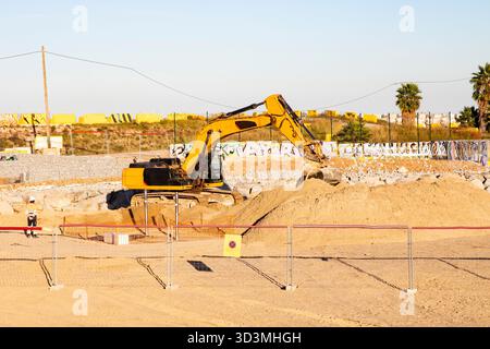 Yellow excavator working at outdoor construction site, Barcelona Spain 27.10.2025 Stock Photo