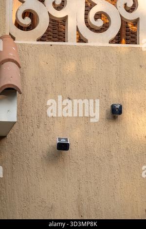 Technology comparison of two mounted outdoor wireless security cameras: Amazon's blink and Eufy solar-powered S220 Stock Photo