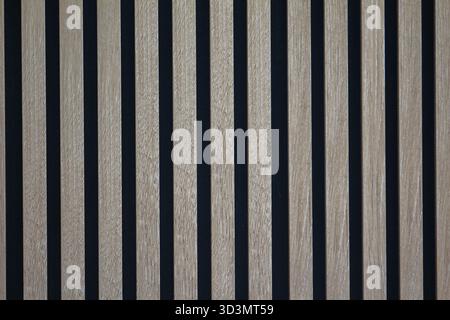 Architectural element featuring vertical wooden stripes and dark spaces, perfect for design inspiration. Stock Photo