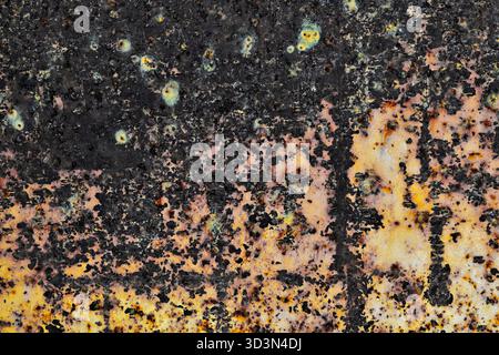 Rust oxidization pattern background on faded yellow paint metal surface abstract old worn out. Stock Photo