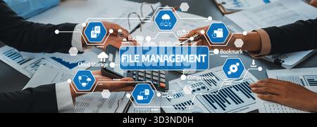 This image showcases file management practices in a modern office setting, highlighting collaboration through technology and efficient processes for Stock Photo