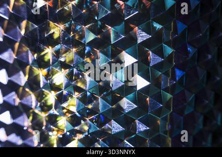 Mesmerizing abstract background with geometric pattern of colorful iridescent triangles. magical crystal reflection of light creates futuristic and vi Stock Photo