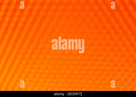 Orange yellow vibrant abstract background. The blurred geometric hexagonal pattern creates a warm, intense, and dynamic texture Stock Photo