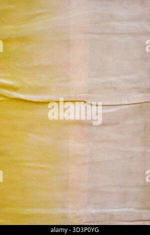 Old blank bright yellow ripped torn grunge posters backgrounds creased crumpled paper backdrop surface placard empty space for text Stock Photo