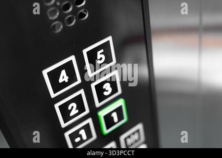 Elevator control panel showing pressed button in a modern building Stock Photo