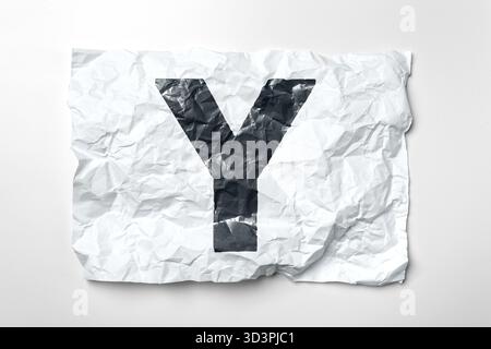 Crumpled paper with large black letter Y showing texture and design elements Stock Photo