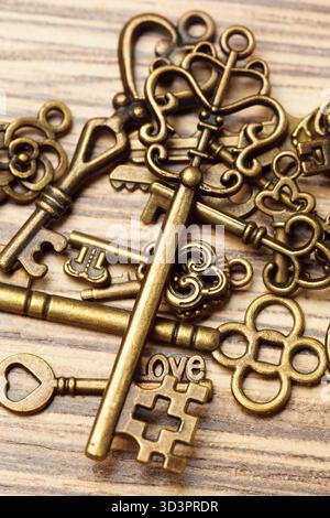 Vintage keys arranged beautifully on a wooden surface for an aesthetic touch Stock Photo