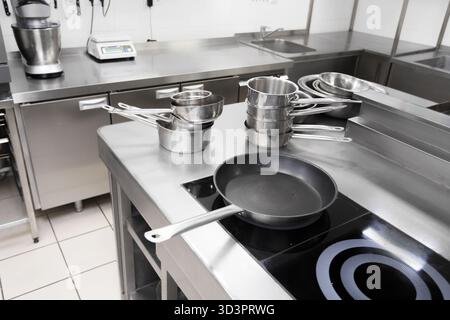 Modern kitchen workspace with various cooking tools and clean surfaces for meal preparation Stock Photo