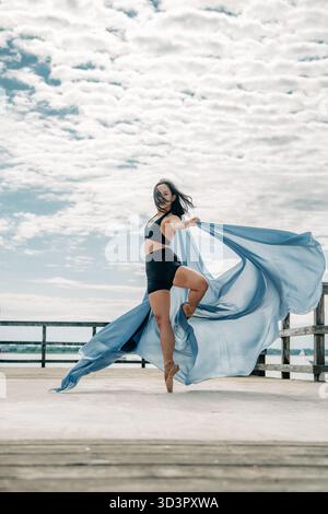 Female ballet dancer performing en pointe with fabric Stock Photo