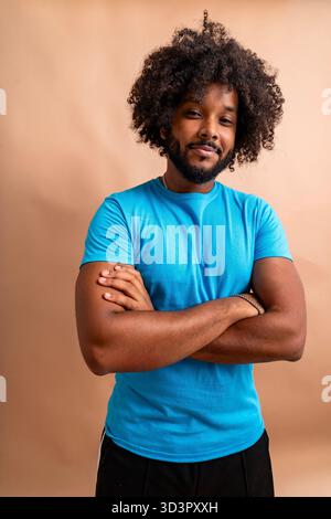 Confident black man smiling with arms crossed Stock Photo