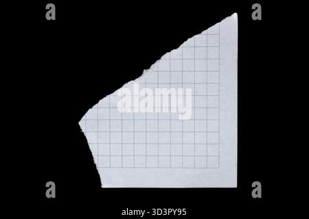 Torn graph paper piece isolated on black background Stock Photo