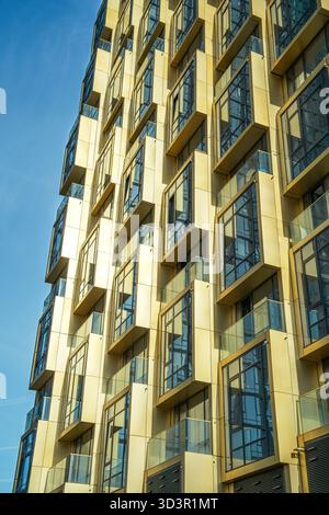 A striking image of modern architecture in Moscow, showcasing a building's detailed geometric facade with glass and gold-toned panels, highlighting ur Stock Photo