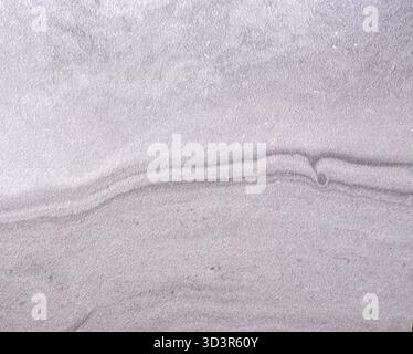 Gray marble, wavy natural stone pattern with inclusions, close-up. Seamless background texture. Stock Photo