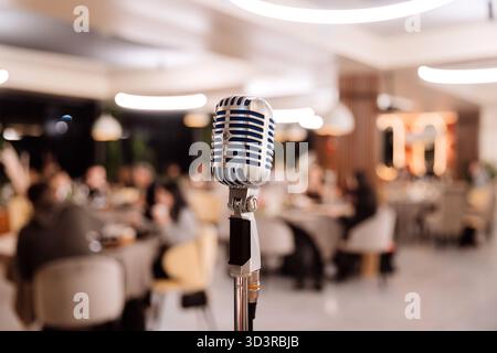 Retro microphone on stage in elegant restaurant ready for live performance Stock Photo