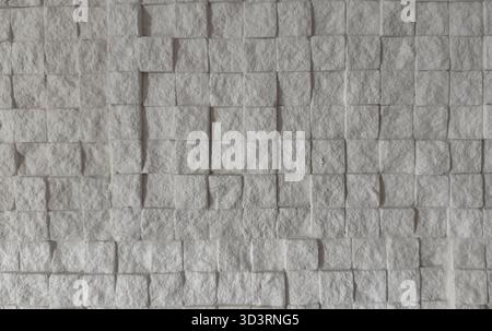 Close-up of white stone wall made of square tiles showing geometric 3D texture Stock Photo
