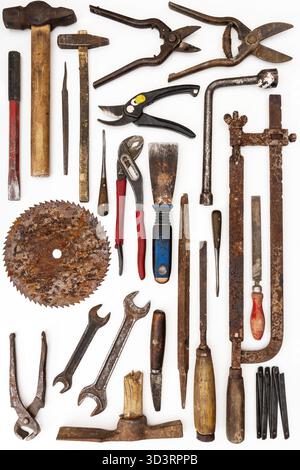 Flat lay of old hand tools on white background. Large collection of various rusty tools and bits arranged on white. Stock Photo