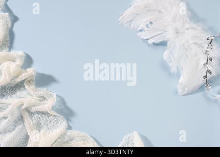 White feathers on pastel blue background in soft daylight. Stock Photo