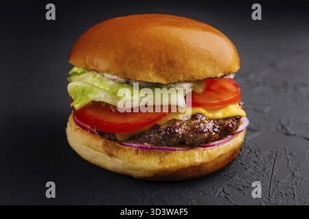 Food, Appetizing cheeseburger on black stone closeup Stock Photo