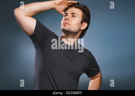 Young handsome man posing on gray background Stock Photo