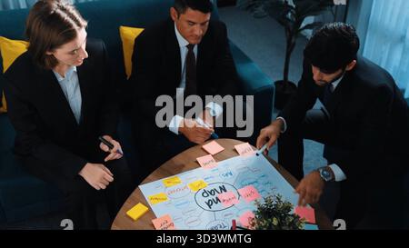 Top view of skilled businessman write marketing idea and drawing mind map while project manager explain financial strategy at meeting room Stock Photo