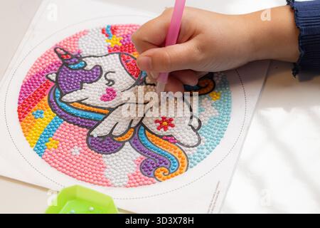 Child Hand Doing Diamond Painting Unicorn Close Up Stock Photo