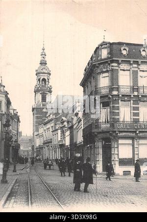 This photograph shows Rue de Nimy and the Church of Sainte-Elisabeth in Mons, Belgium, although the specific date is unknown. The image captures both the street and church architecture. Stock Photo