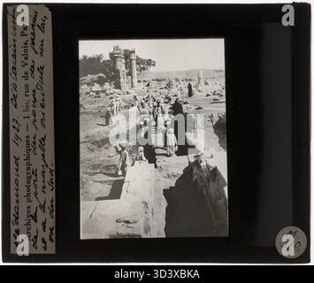 This glass diapositive from circa 1927 depicts workers digging up the gate of the granary and the eastern wall of the Holy Lake at the Medamud Temple of Montu. The photograph is taken from the south. Stock Photo