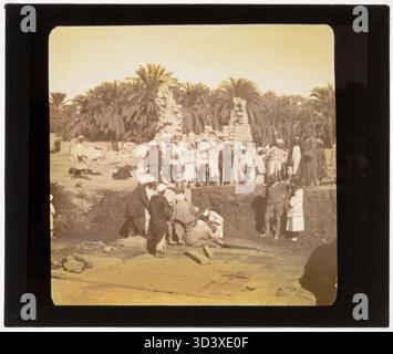 A glass diapositive, taken circa 1926, showing workers digging up the entrance to the crypt at the Temple of Montu, a key part of the excavation process in Medamud. Stock Photo