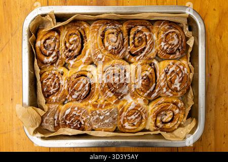 cinnamon buns wooden kitchen table Stock Photo