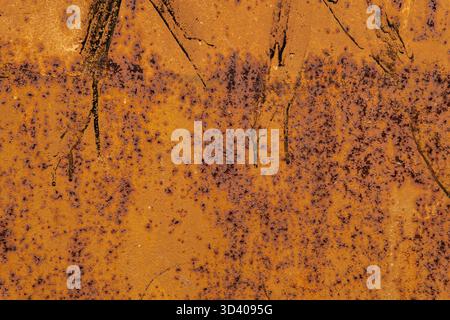 Rust texture abstract close-up with dark streaks and vivid orange-brown colors. Stock Photo